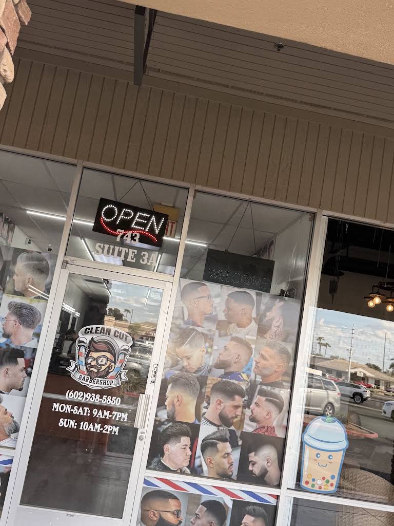 Clean Cut's actual Suite 3A storefront, with its barber logo, haircut posters and open sign